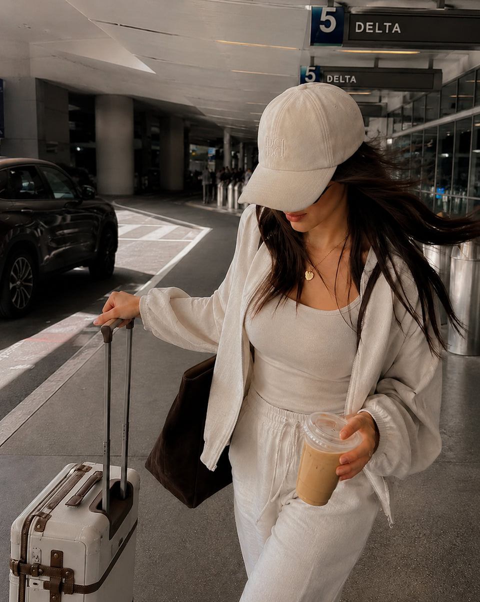 Woman wearing the BOLLIDE Silk-Lined Hat while traveling through the airport