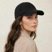The Silk-Lined Cotton Twill Hat in Black, worn by a model