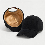 The Silk-Lined Cotton Twill Hat in Black, exterior and silk-lined interior