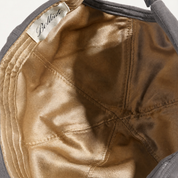 BOLLIDE Silk-Lined Hat in Charcoal, champagne-gold silk interior close-up