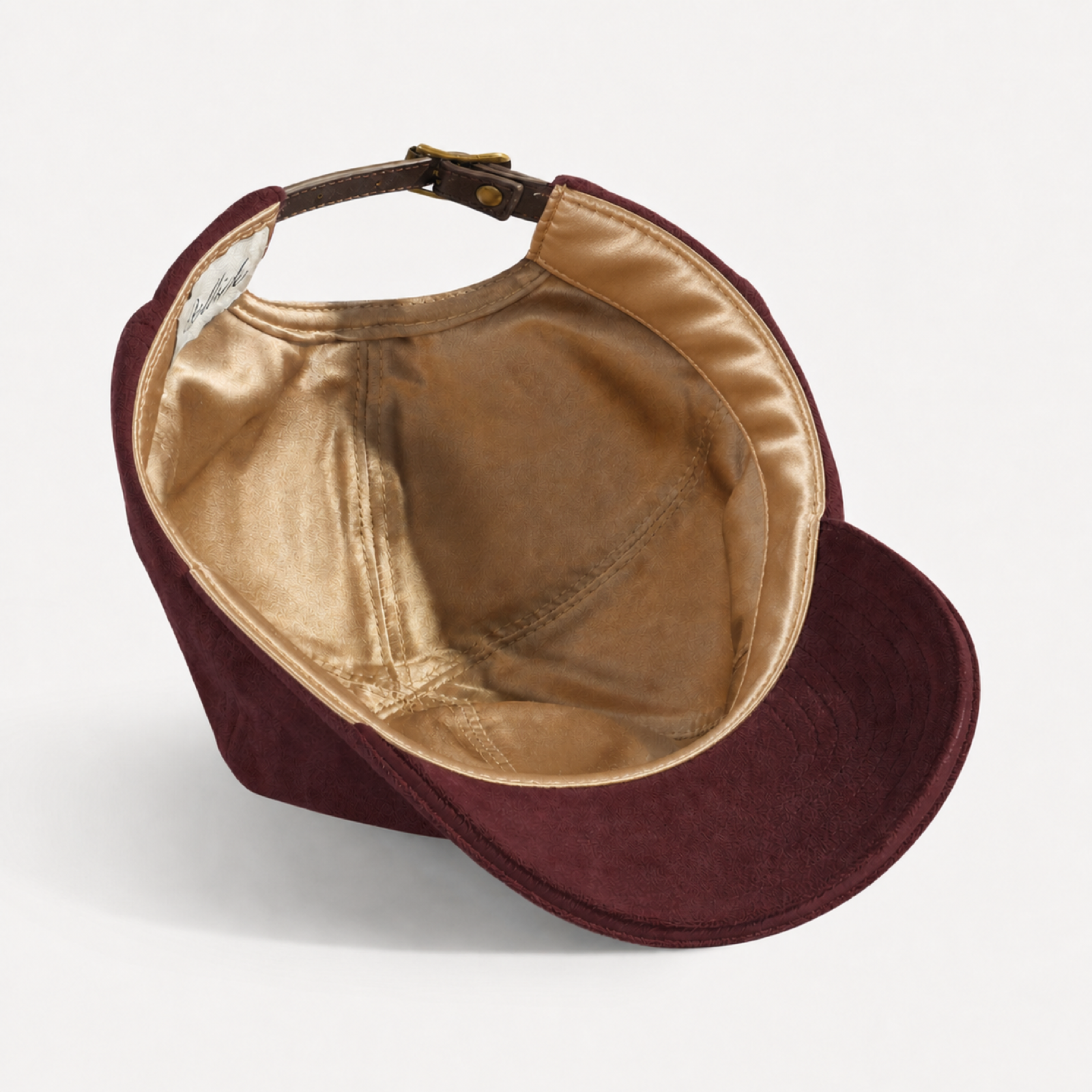 The Silk-Lined Hat in Oxblood, champagne-gold silk interior and silk sweatband