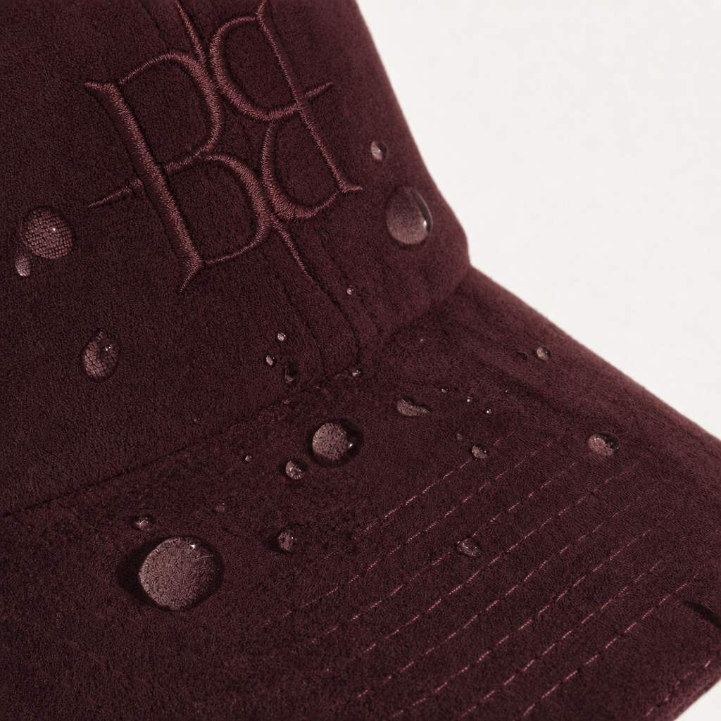 The Silk-Lined Hat in Oxblood, water-resistant suede detail