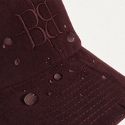 The Silk-Lined Hat in Oxblood, water-resistant suede detail
